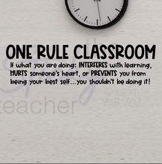 a clock with the words one rules classroom written on it and an image of a person's face