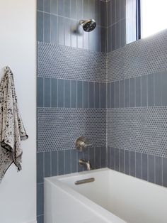 a bath tub sitting next to a window in a bathroom