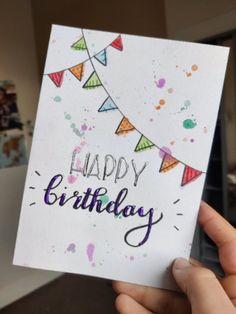 someone holding up a birthday card with the words happy birthday on it