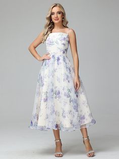 a woman wearing a white and purple dress with flowers on the bodicet skirt