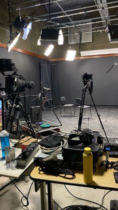 an empty room with several cameras and equipment