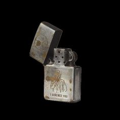 an old metal lighter with graffiti on it's side and the words, i carried you