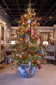 a decorated christmas tree in a blue and white vase with an american flag on it