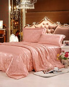 A luxurious bedroom with an ornate design features a king-sized bed adorned in the 19 Momme Jacquard Silk Bedding Set - 4Pcs from SusanSilk Jacquard Bedding, Silk Bedding Set, Best Sheets, Mulberry Silk Fabric, Silk Sheets, Silk Bedding, Light Coral, Pink Bedroom, Jacquard Pattern