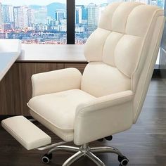 a white office chair sitting in front of a desk