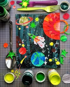 an art project with paint, paper and spoons