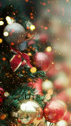 a christmas tree with ornaments and lights in the background