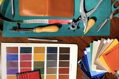 there are many different colors and tools on the table with it's contents laid out