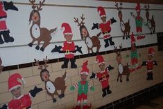 christmas decorations are hanging on the wall in front of santa's hats and reindeers