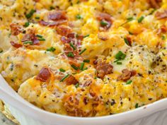 a casserole dish with cheese, bacon and chives