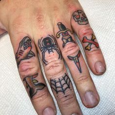 a hand with some tattoos on it and a spiderweaver in the middle