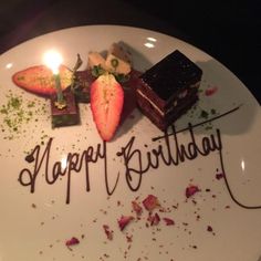 a birthday plate with chocolate and strawberries on it