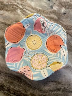 an orange and blue plate sitting on top of a marble counter