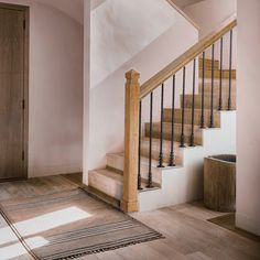 a stair case next to a wooden door