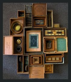 an assortment of old items are arranged in a square arrangement on the floor, including boxes and telephones