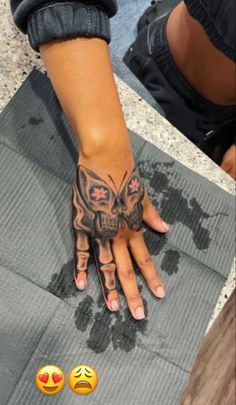 a person's hand with tattoos on it