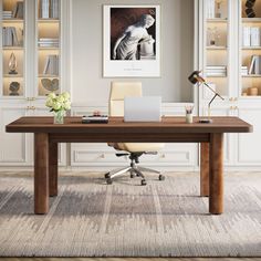 a desk with a laptop on it in front of a bookcase and bookshelves