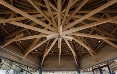 the inside of a building with wooden beams