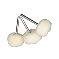 three balls of white wool on top of each other with metal pins in the middle