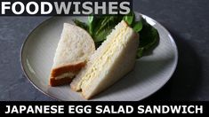 an egg salad sandwich on a plate with lettuce