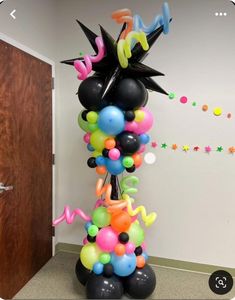 the balloon column is decorated with black, white, and multicolored balloons