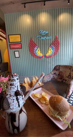 a table topped with a burger and fries