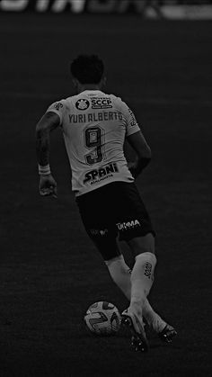 black and white photograph of a soccer player in action on the field during a game