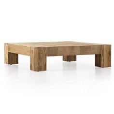 a wooden coffee table sitting on top of a white floor