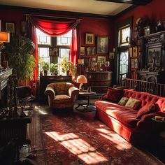 a living room filled with lots of furniture and windows covered in red draping