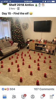 a living room decorated for christmas with red cones on the floor