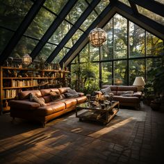 a living room filled with lots of furniture under a glass roof covered in trees and plants