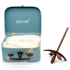 an open blue suitcase sitting next to a wooden stick