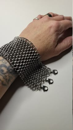 **All orders placed on or after December 3rd are not guaranteed to arrive before Christmas!! As its only me handmaking each item all available dates have been filled. I make each order in the order i receive them. My apologies for any inconvenience This is a slinky chunky dragonscale bracelet made from 100% stainless steel. Very flexible and comfortable to wear Feels cool on the skin. The pattern is a set of large rings with smaller rings going through the center of the weave. Making this weave dense. This is a heavy bracelet. Any returns will be subject to a 20% restocking fee. This portion of your payment will be non-refundable. Find more videos of my creations @dredmouse on Tiktok!    Check out my page for a 20 percent discount code! Dragonscale Chainmail, Chainmail Glove, Joan Of Arc Costume, Etsy Shop Branding, Chainmail Bracelet, Large Ring