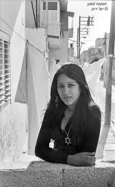 black and white photograph of a woman leaning on a ledge