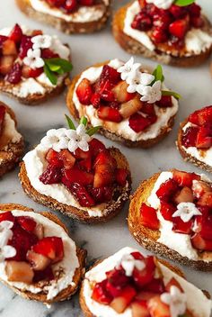 several small crostini with ricotta and strawberries on them are shown here