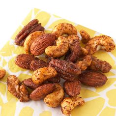 nuts are sitting on a yellow and white napkin