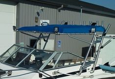 a white and blue boat parked in front of a building