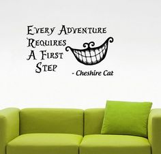 a green couch sitting in front of a wall with a quote on it that says every adventure requires a first step