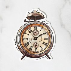 an old fashioned clock sticker on a white marble counter top with a bell in the middle