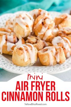 cinnamon rolls on a plate with icing drizzled over them and the words mini air fryer cinnamon rolls