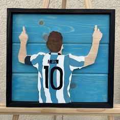 Introducing our stunning handmade 3D wooden art piece featuring Lionel Messi, expertly crafted with a scroll saw technique and framed to perfection. Every detail is meticulously brought to life, showcasing Messi's legendary presence. With carefully chosen wood stains and a custom frame, this piece adds elegance and sportsmanship to any space. Wood Stains, Scroll Saw, Wooden Art, Lionel Messi, Staining Wood, Custom Framing, Wall Hangings, Beauty Book, Art Pieces