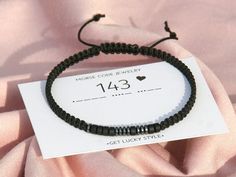 a black beaded bracelet with a heart on it