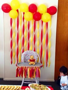 a baby's first birthday party with balloons and food