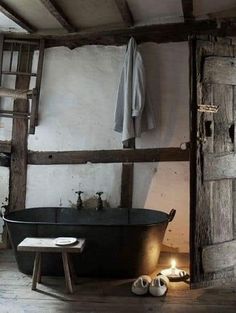 an old fashioned bathtub in a rustic bathroom