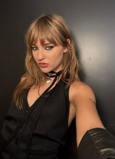 a woman in black shirt and leather gloves