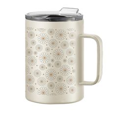 a stainless steel mug with a flower design on the front and side, in white