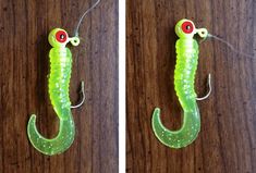 two pictures of a green fish with red eyes and long legs, hanging from hooks