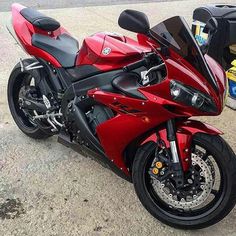 a red motorcycle is parked on the street