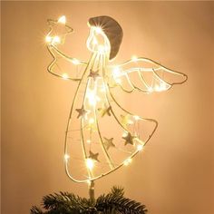 a christmas tree topper with lights on it and an angel figure in the middle