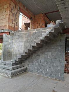 a concrete staircase in front of a building under construction